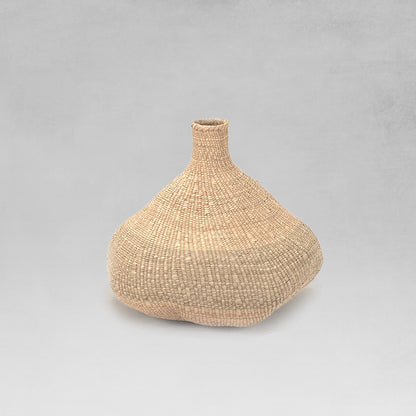 Handwoven medium binga basket with light gray background.