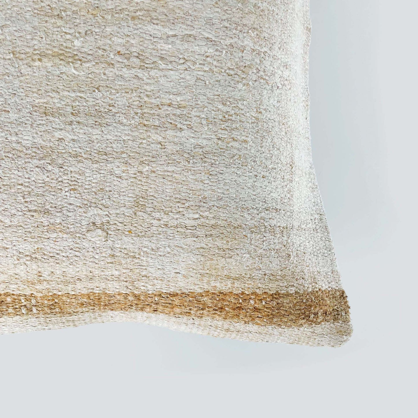 Handwoven Turkish kilim hemp pillow cover in sand with light caramel stripes.