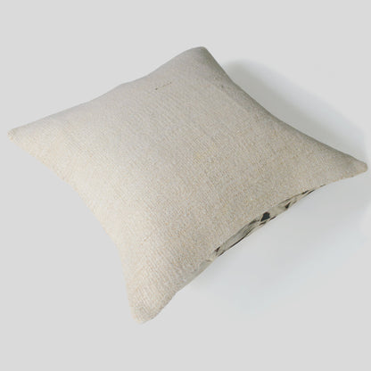 Beige pillow on a light gray background.