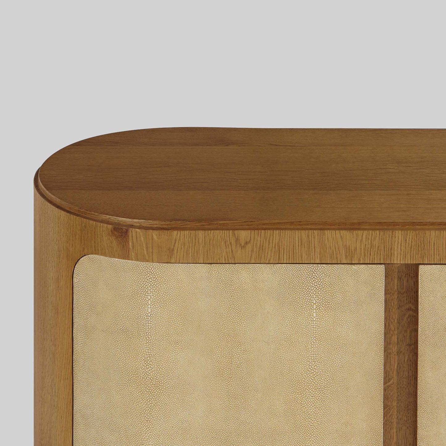 Natural oak sideboard with shagreen finished door panels on gray background.