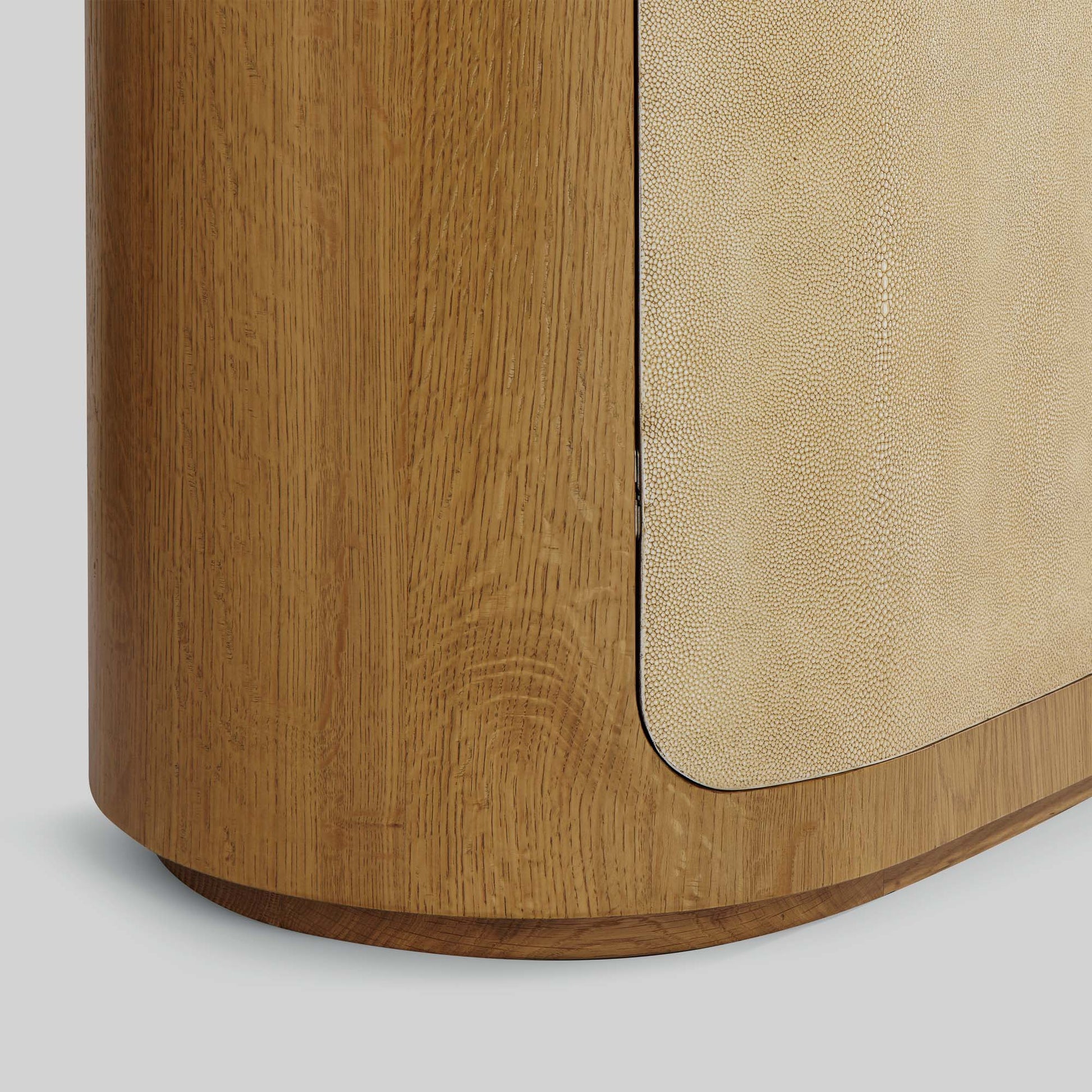 Natural oak sideboard with shagreen finished door panels on gray background.