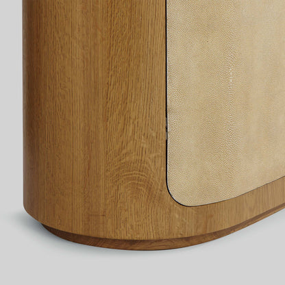Natural oak sideboard with shagreen finished door panels on gray background.
