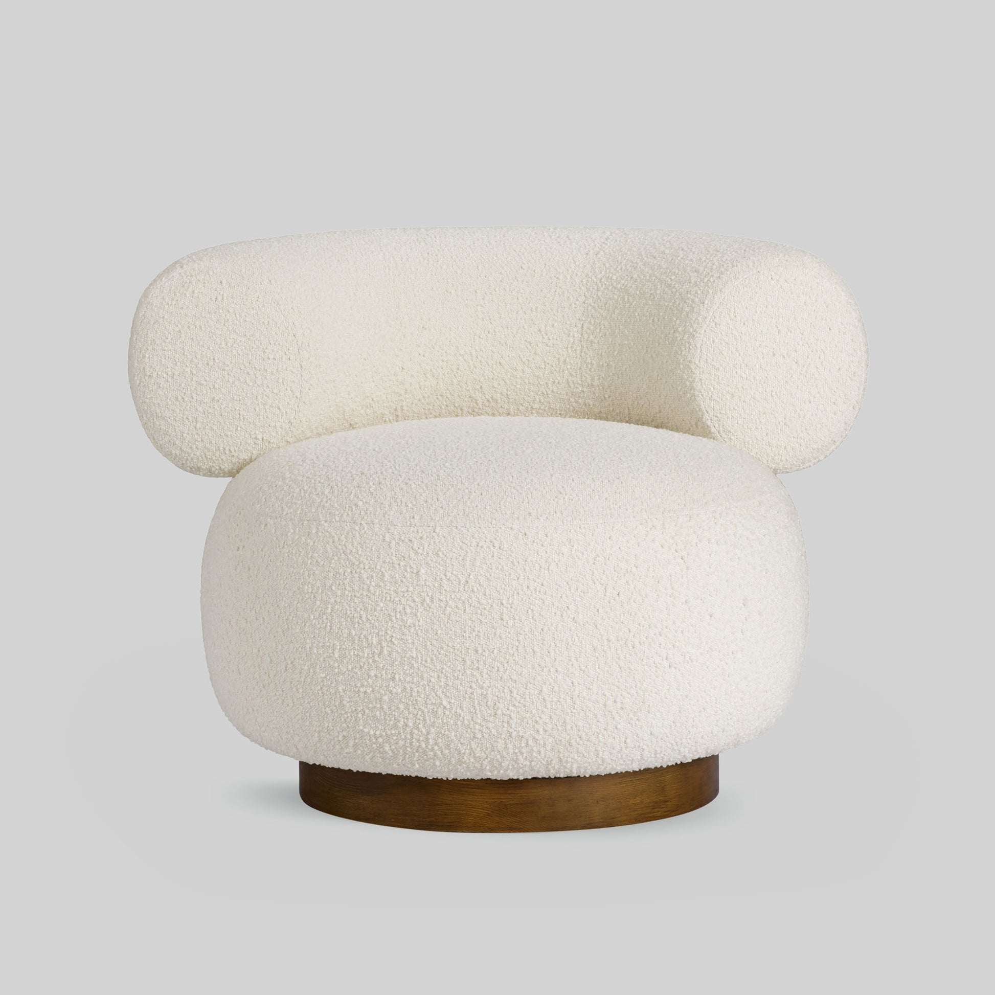 Light colored boucle fabric swivel chair on gray background.