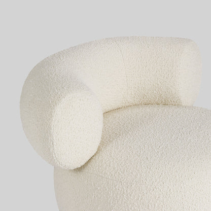 Light colored boucle fabric swivel chair on gray background.