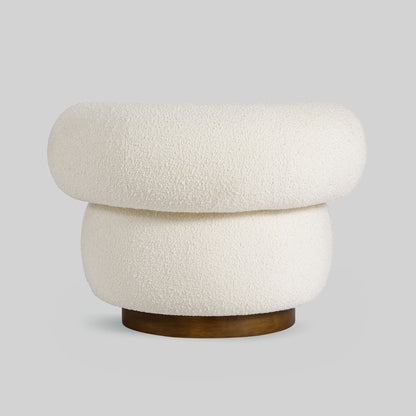 Light colored boucle fabric swivel chair on gray background.