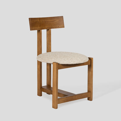 Wooden chair with a cushioned seat on a white background