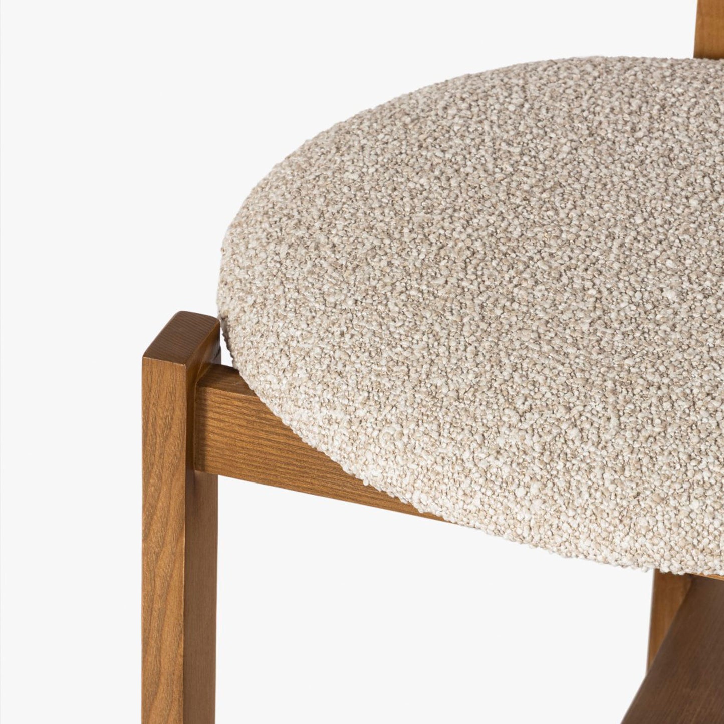 Close-up of a chair with a textured beige cushion and wooden frame on a white background