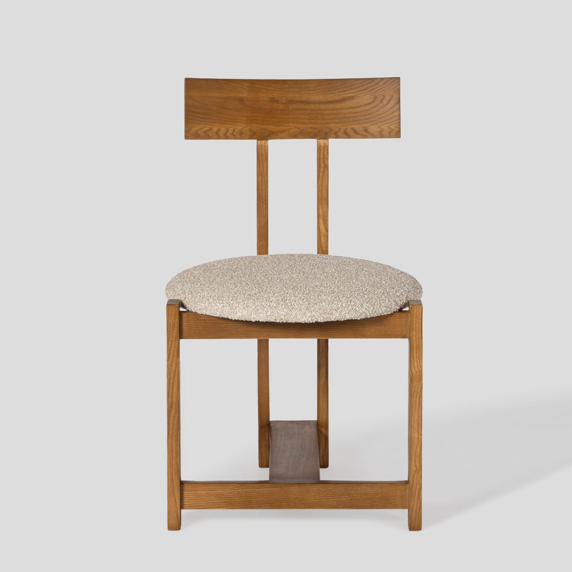 Wooden chair with a cushioned seat on a white background