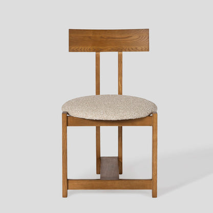 Wooden chair with a cushioned seat on a white background