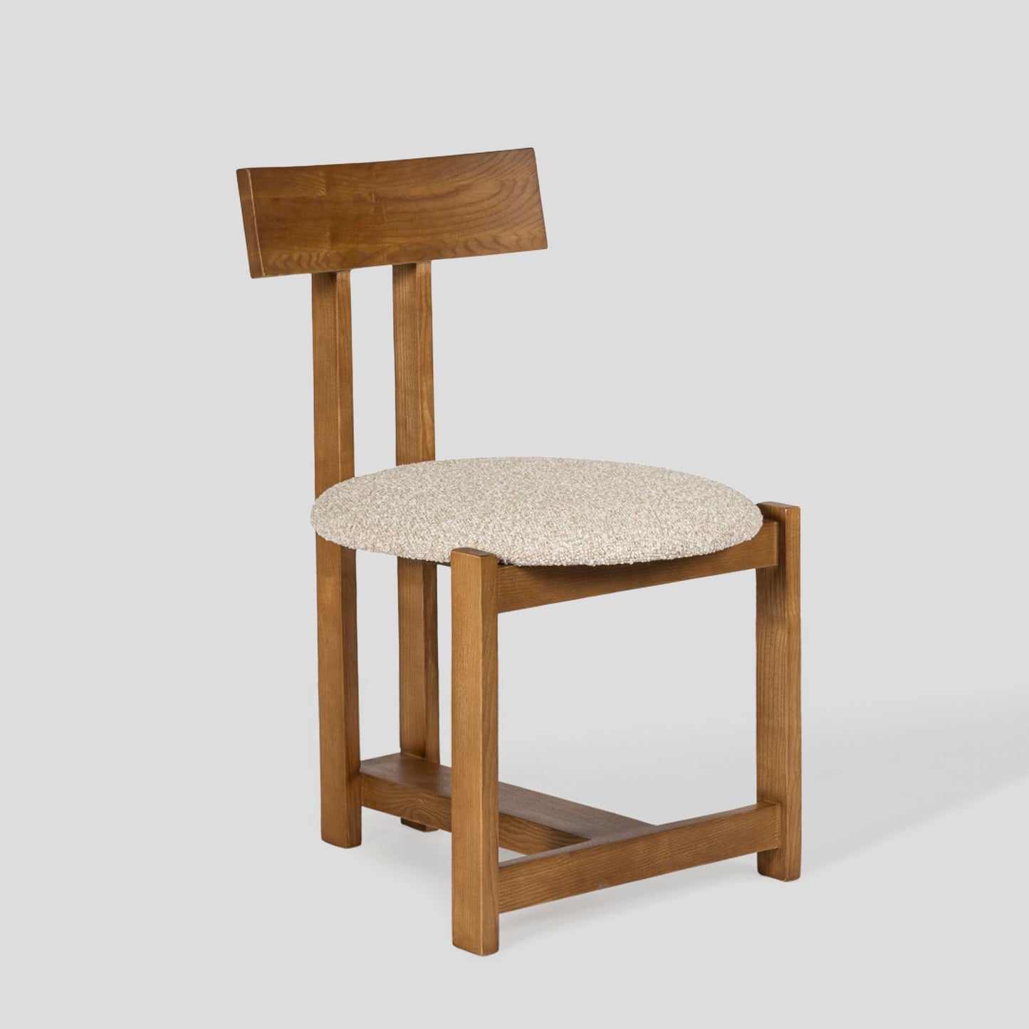 Wooden chair with a beige cushion on a white background