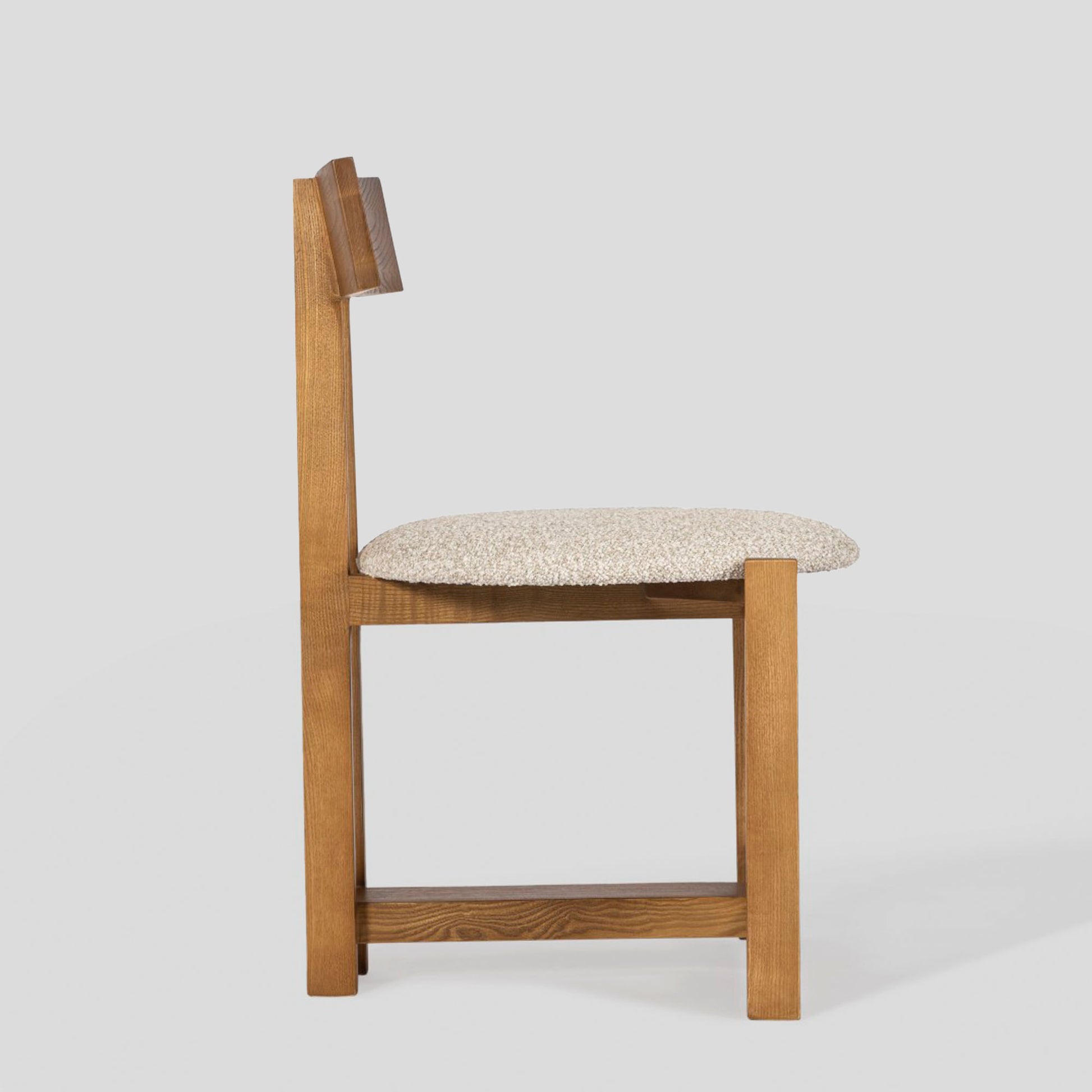 Wooden chair with a patterned cushion on a white background