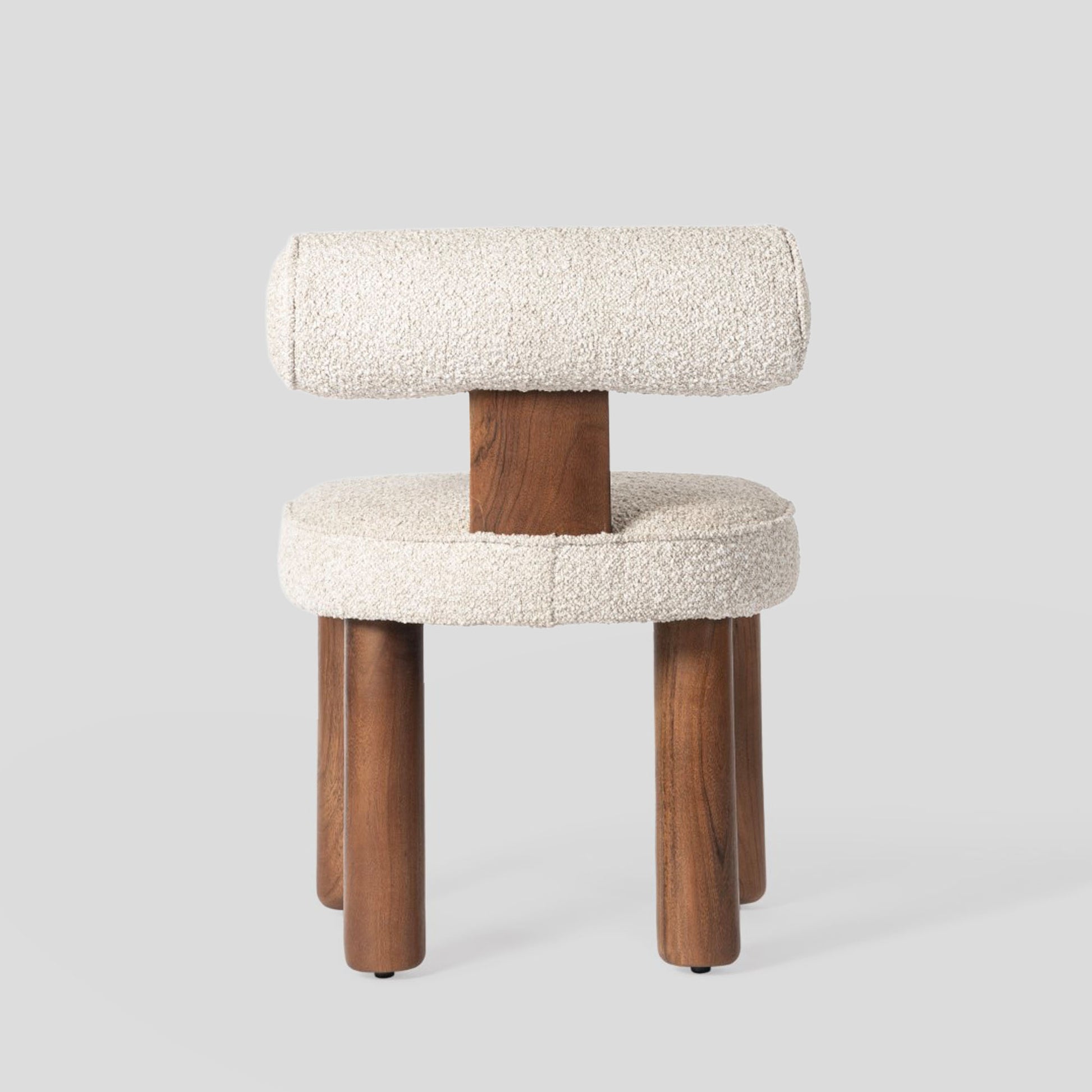 Chair with wooden legs and textured white cushioned backrest on a light gray background