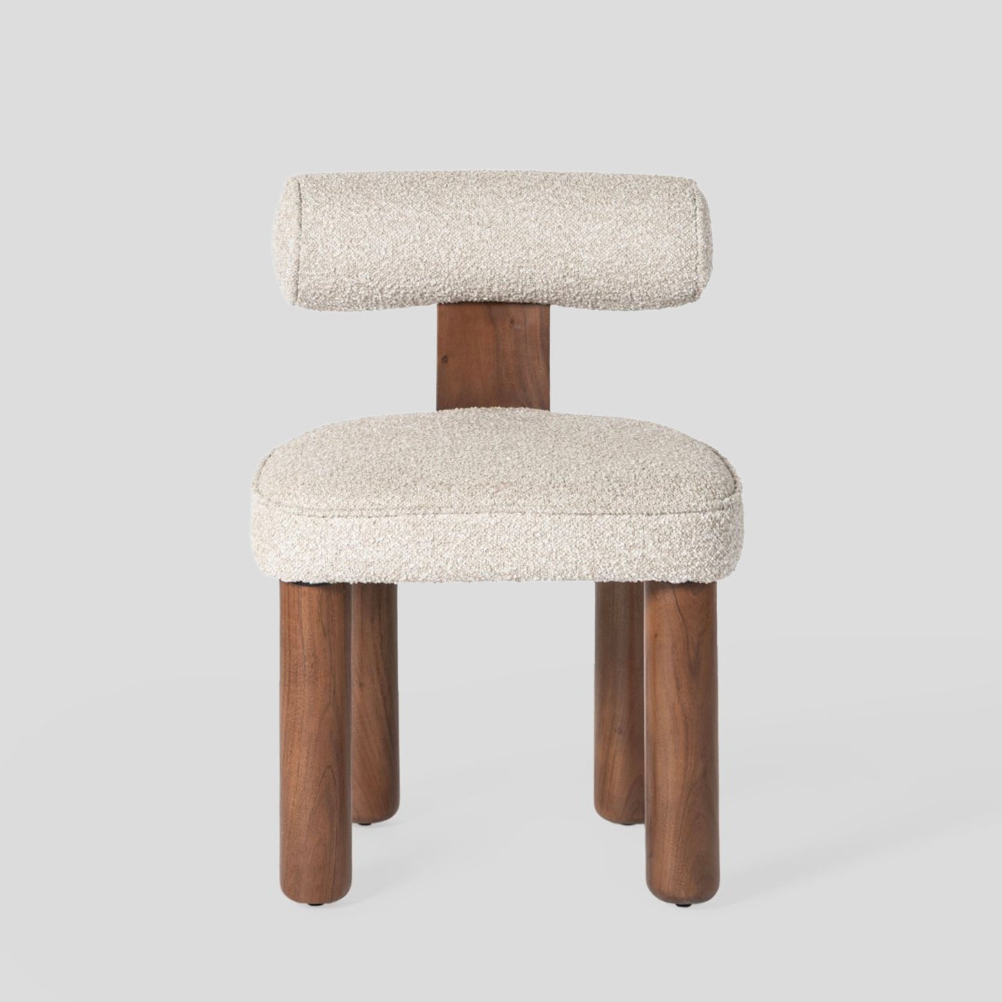 Chair with wooden legs and white cushioned seat and backrest on a light gray background