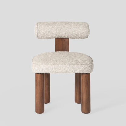 Chair with wooden legs and white cushioned seat and backrest on a light gray background