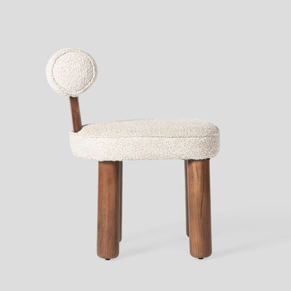 Small chair with a textured white seat and backrest on a light gray background