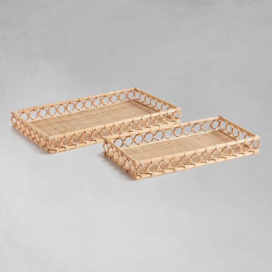Lattice rectangular rattan serving trays with gray background.