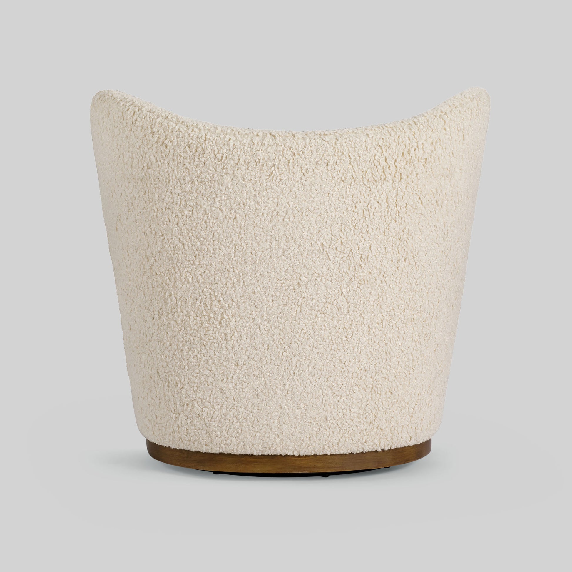Cream toned sherpa fabric textured lounge chair on gray background.