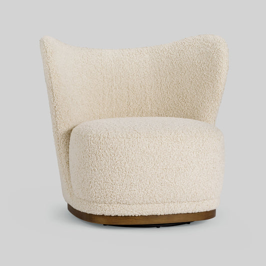 Cream toned sherpa fabric textured lounge chair on gray background.