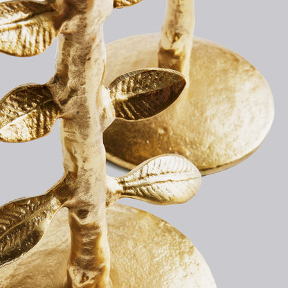 Closeup view of Set of two leaf candleholders in gold.