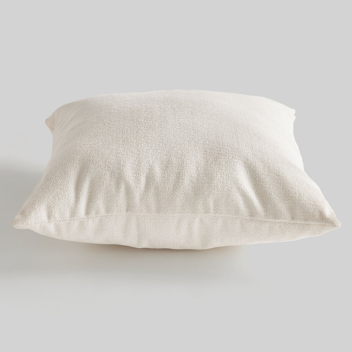 Light cream jacquard square pillow for home decor and accessories.