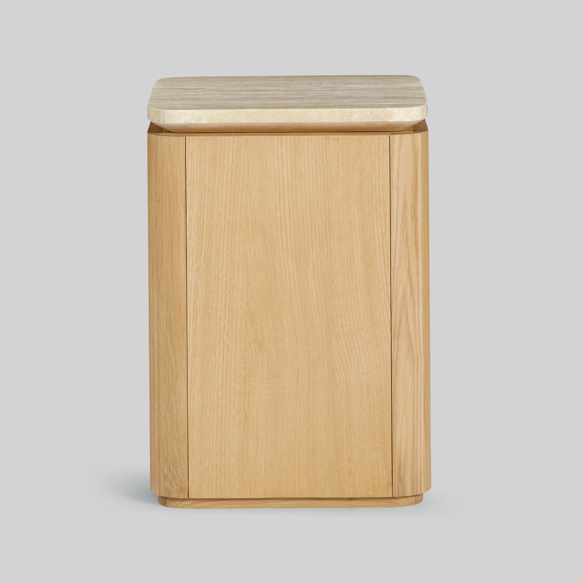 Wooden side table with a light oak finish and travertine top on a gray background.