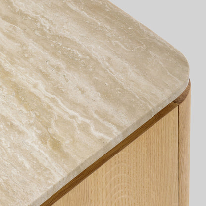 Wooden side table with a light oak finish and travertine top on a gray background.