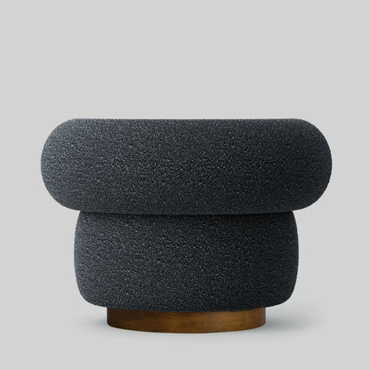 Gray textured fabric armchair on a light gray background.