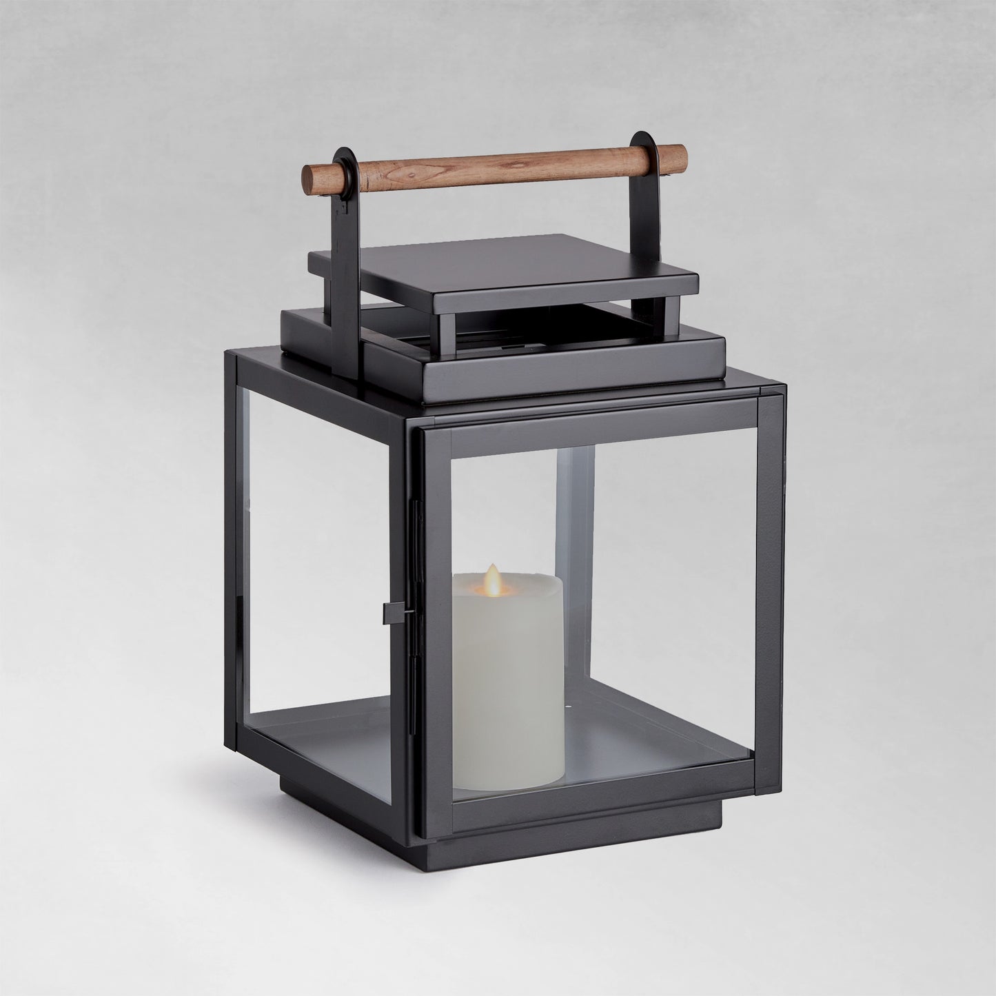 Medium metal outdoor lantern with black finish with gray background.