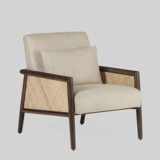 Beige armchair with cane arms and wooden frame on a light gray background.