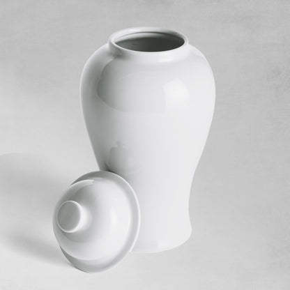 Mini white ceramic ginger jar with lid removed with gray background.