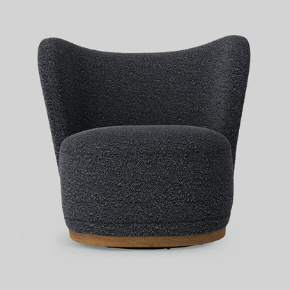 Dark gray boucle fabric lounge chair on gray background.