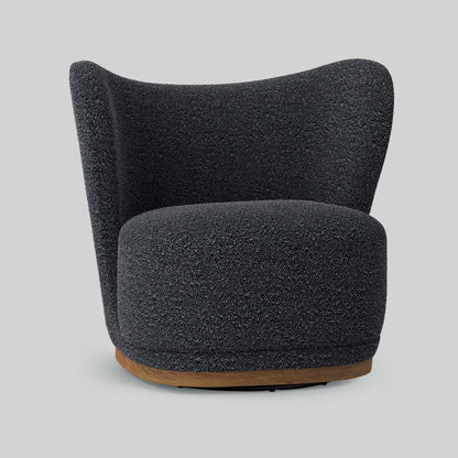 Dark gray boucle fabric lounge chair on gray background.