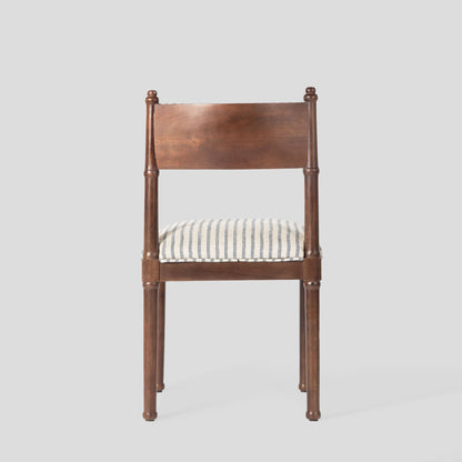 Wooden chair with a striped cushion on a gray background