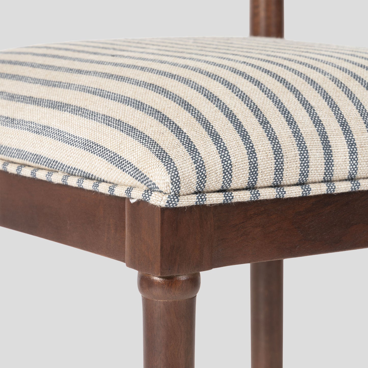 Wooden chair with a striped cushion on a white background