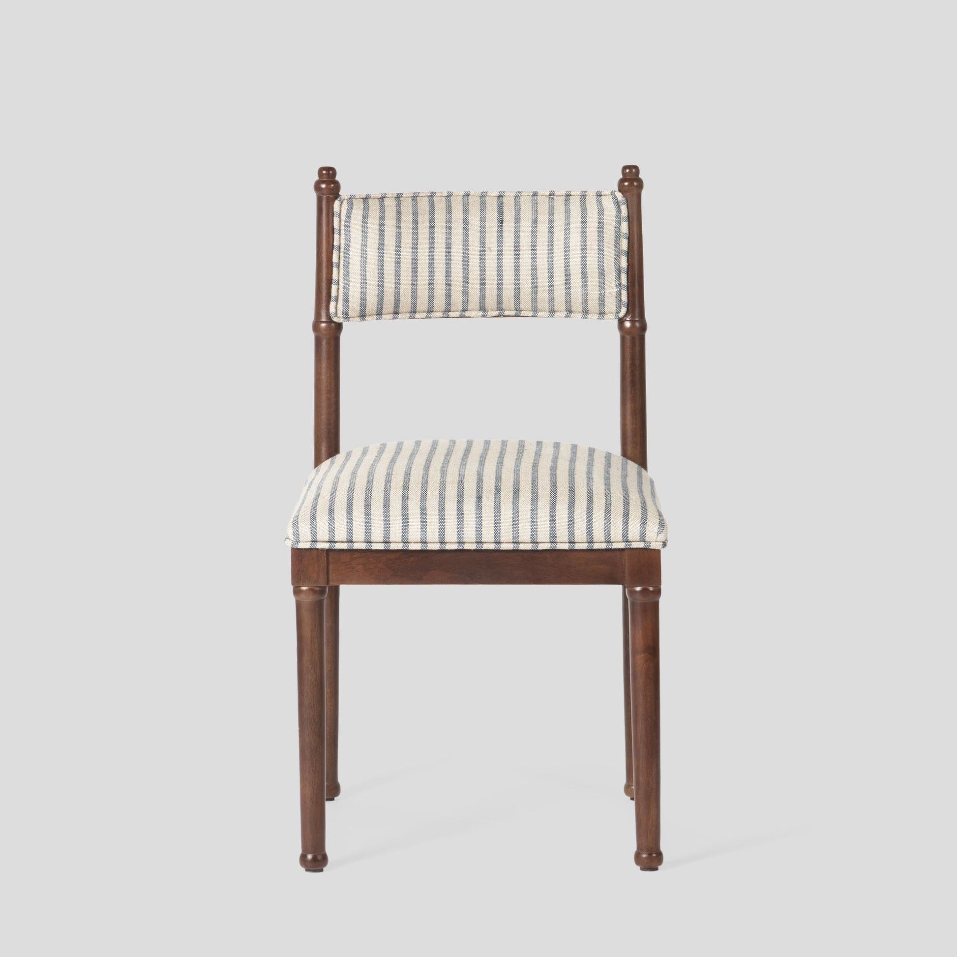 Chair with striped cushion on a light gray background