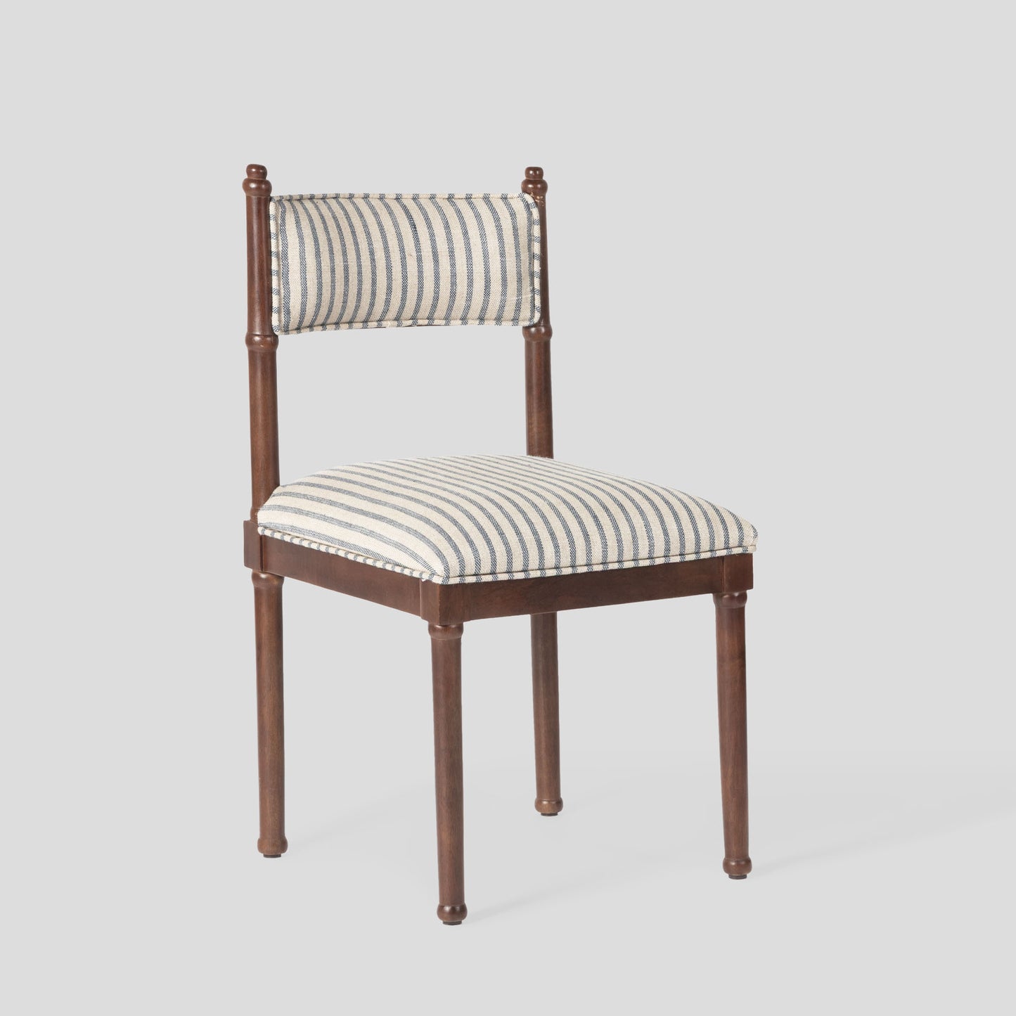 Chair with striped cushion on a light gray background