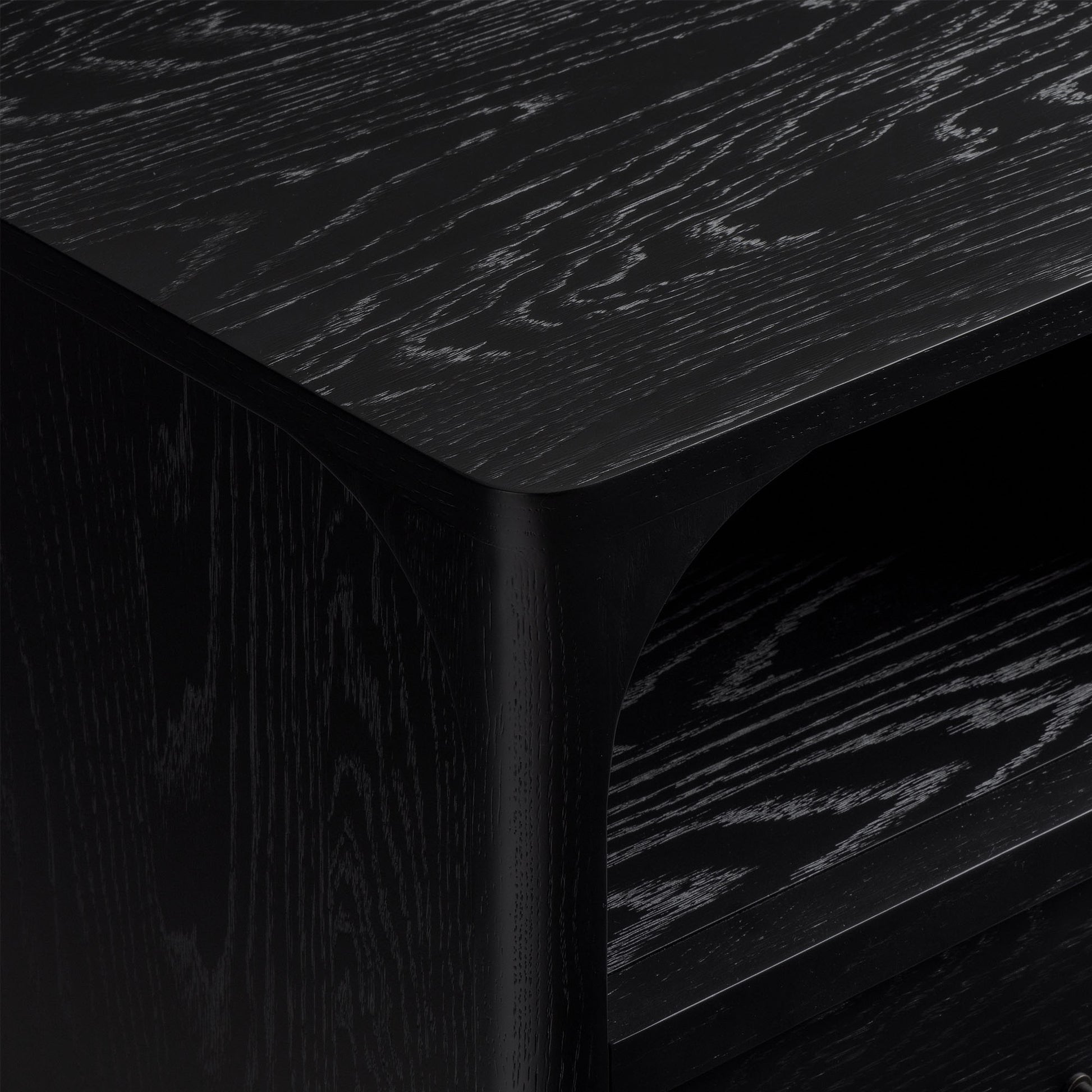 Close-up of black oak nightstand with visible grain texture