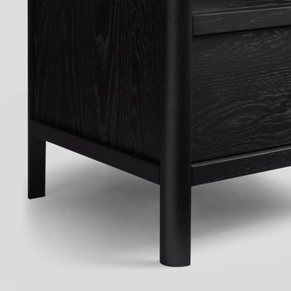 Close-up of a black wooden nightstand with a white background
