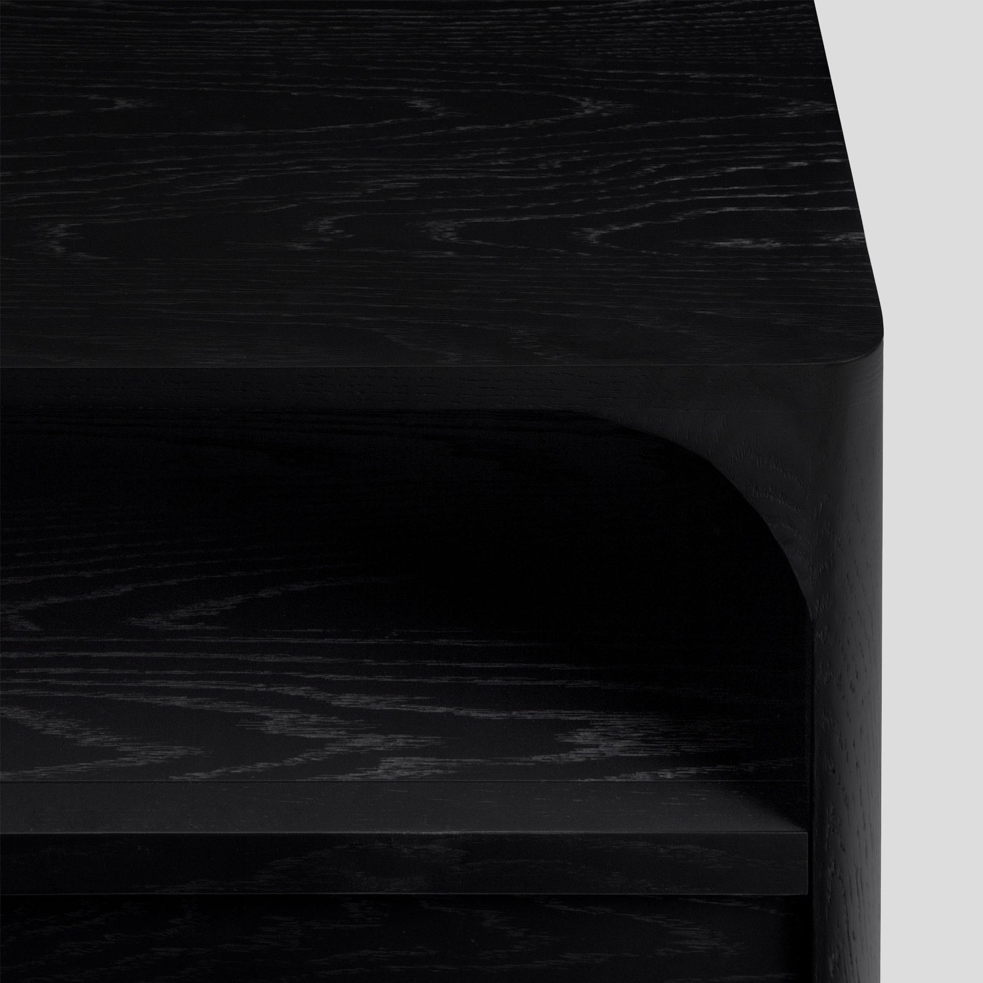 Close-up of black nightstand with a light gray background