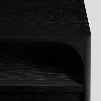 Close-up of black nightstand with a light gray background