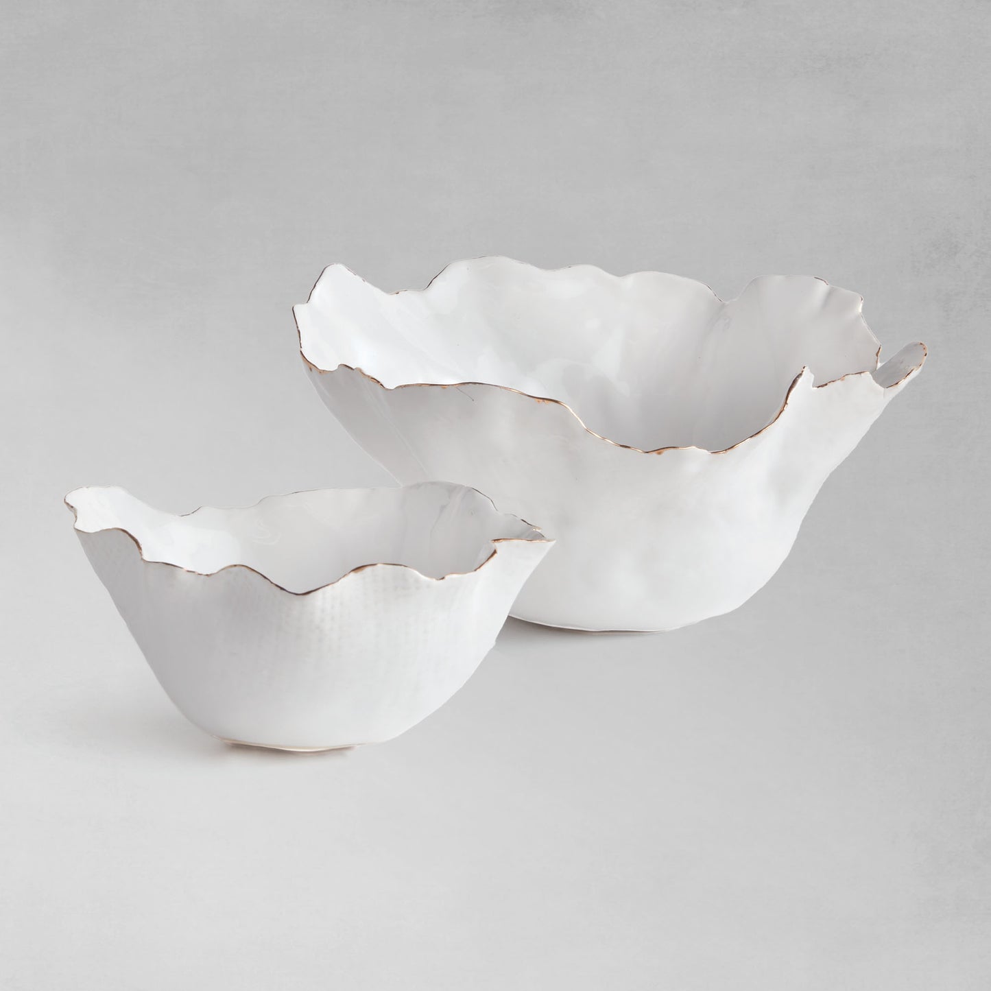 Organic decorative ceramic bowl set with gray background.