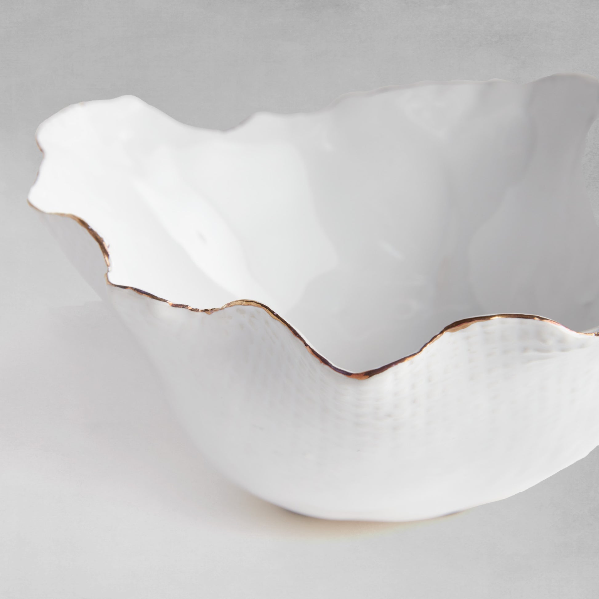 Organic decorative ceramic bowl with gray background.