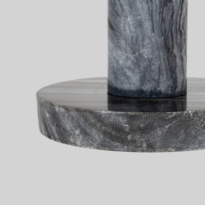 Small round cocktail table with marble top and brass base on a light gray background.