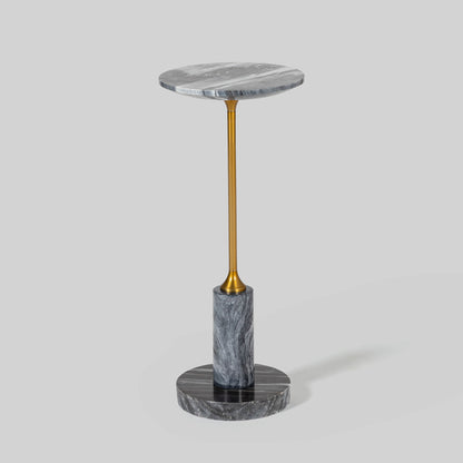 Small round cocktail table with marble top and brass base on a light gray background.
