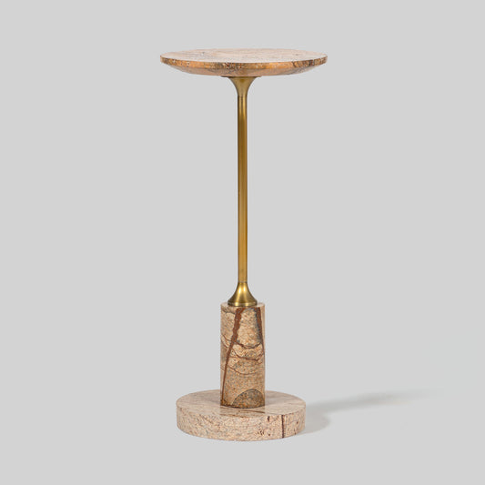 Small round cocktail table with marble top and brass base on a light gray background.
