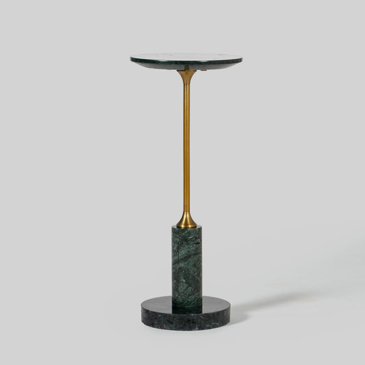 Small round cocktail table with marble top and brass base on a light gray background.