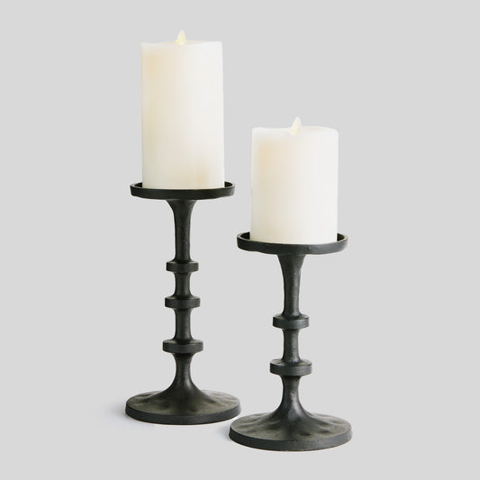 Petite minimalist pillar candleholders, set of 2, black bronze, with gray background.