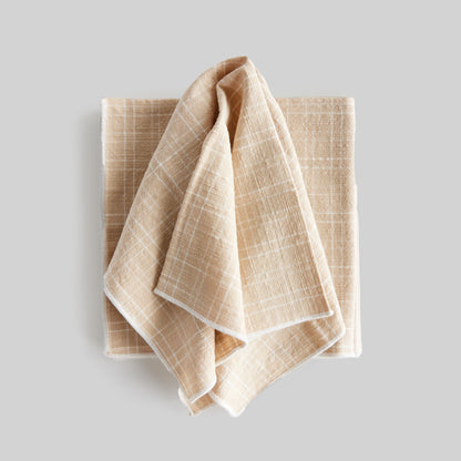 Plaid square cotton dinner napkins set of 4, unfolded, with gray background.