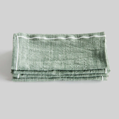 Sage green and white square cotton dinner napkins set of 4, folded and stacked, with gray background.