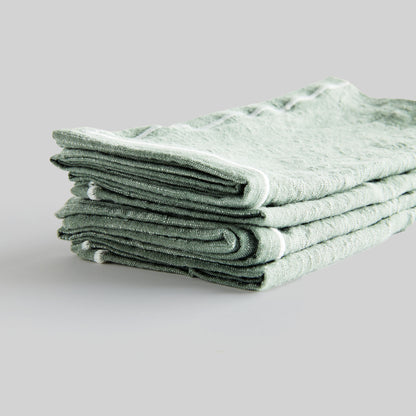 Sage green and white square cotton dinner napkins set of 4, closeup view of edge detailing.